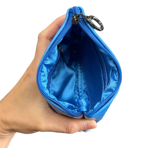 Hand holding a blue pouch with a zipper on a white background