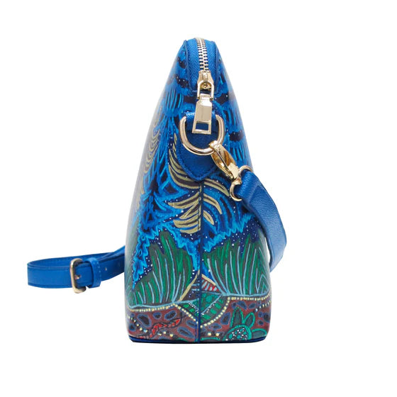 Blue handbag with floral design on a white background