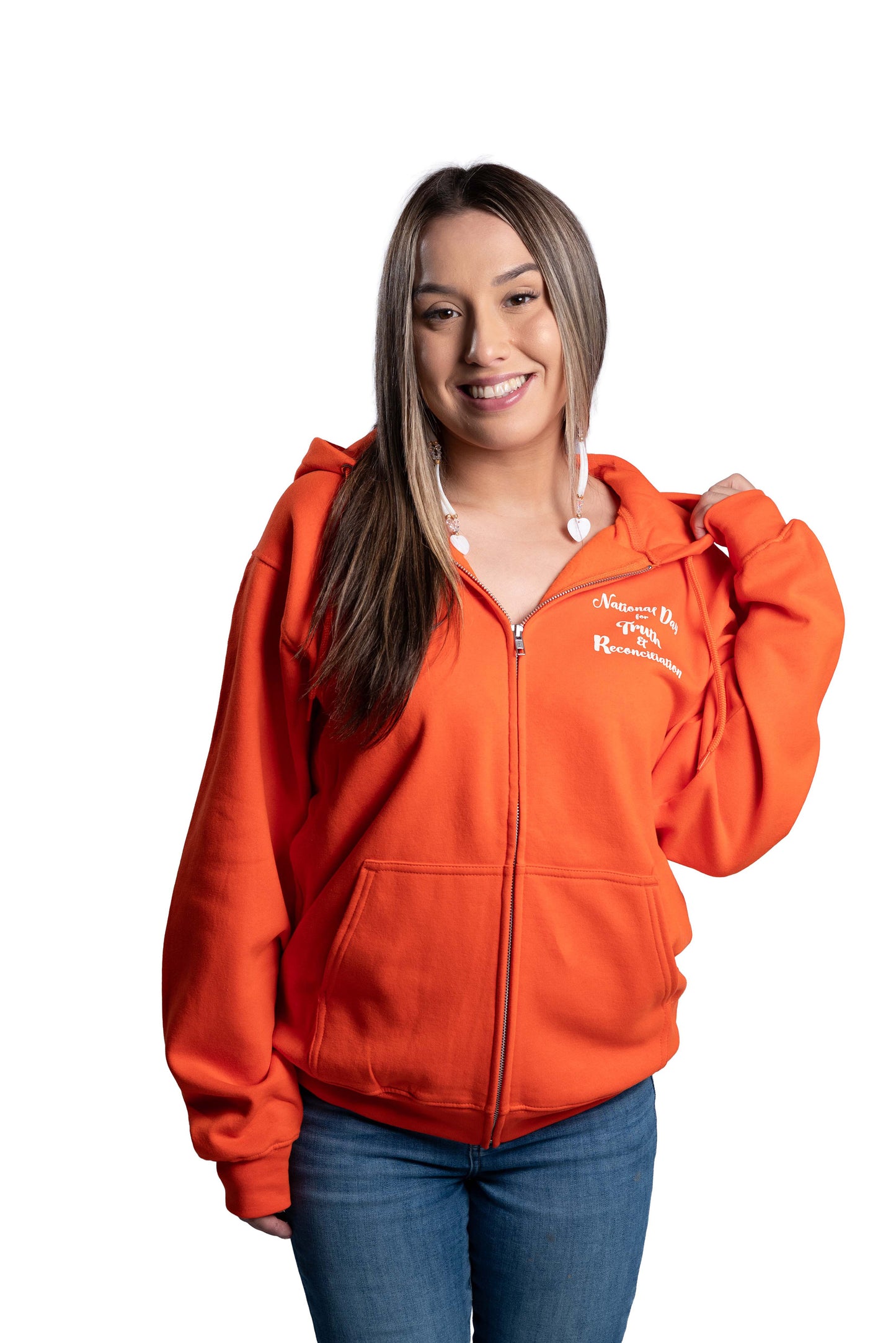 Woman wearing an orange hoodie with a logo on a background