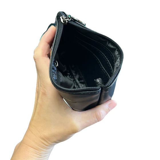 Hand holding a black zippered pouch against a white background