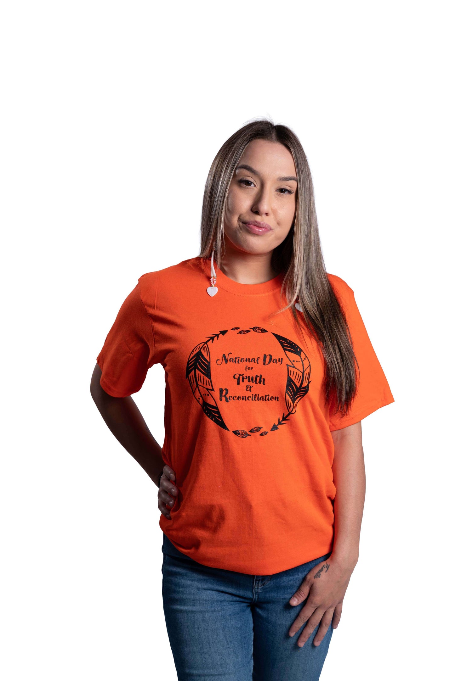 Woman wearing an orange Truth and Reconciliation 2025 unisex t-shirt front view