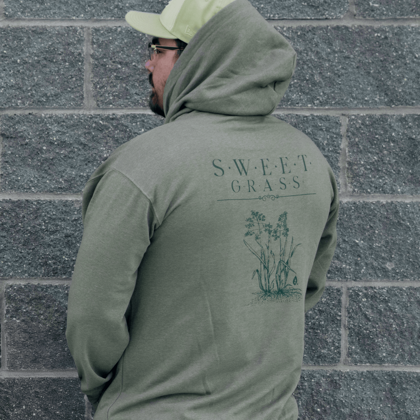 Back view of Sweetgrass Medicine Hoodie showing hood and print