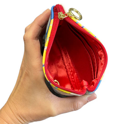 Colorful zip-up pouch held in a hand with a red interior