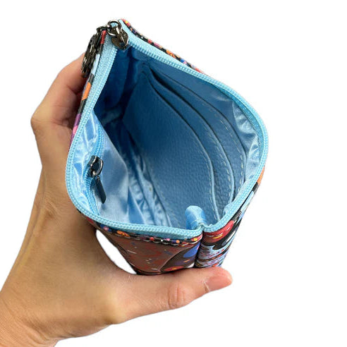 Hand holding a colorful zippered pouch with a blue interior against a white background