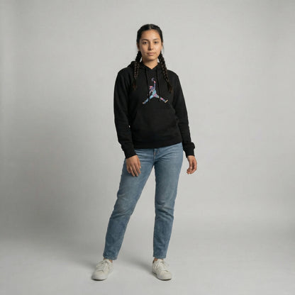 Model wearing Tribal Leap Hoodie in black with colorful graphic, paired with light blue jeans.