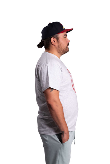 Man wearing a white t-shirt and gray pants on a white background