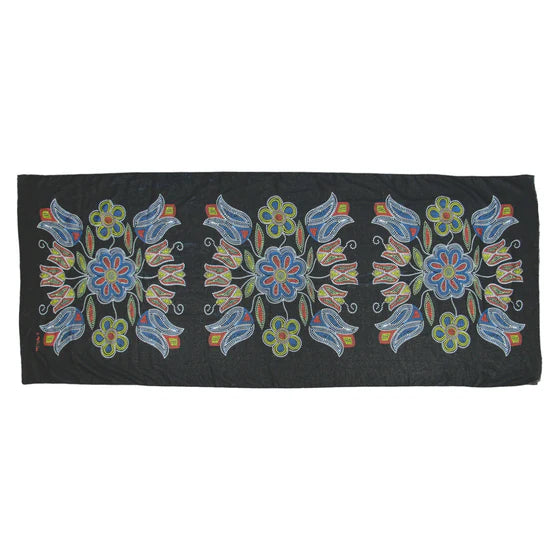 Black fabric with colorful floral embroidery on a white background