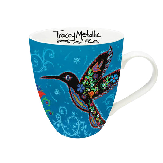 Mug with colorful bird design on a blue background, featuring Tracey Metallics branding.