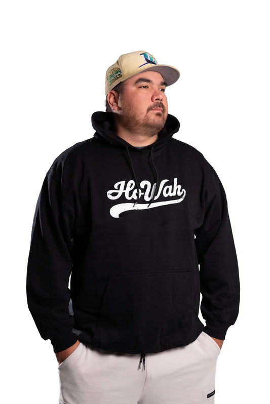 Person wearing a black hoodie with 'Ho Wah' logo and a cap on a white background