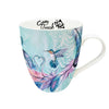 Mug with artistic design of a hummingbird and feathers on a white background