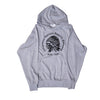 A heather gray pullover hoodie featuring a black circular graphic on the chest with the text 'Indigenous Nations Apparel Company' and 'Estd. 2021' surrounding a profile illustration of a person wearing a feathered headdress.