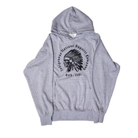 A heather gray pullover hoodie featuring a black circular graphic on the chest with the text 'Indigenous Nations Apparel Company' and 'Estd. 2021' surrounding a profile illustration of a person wearing a feathered headdress.