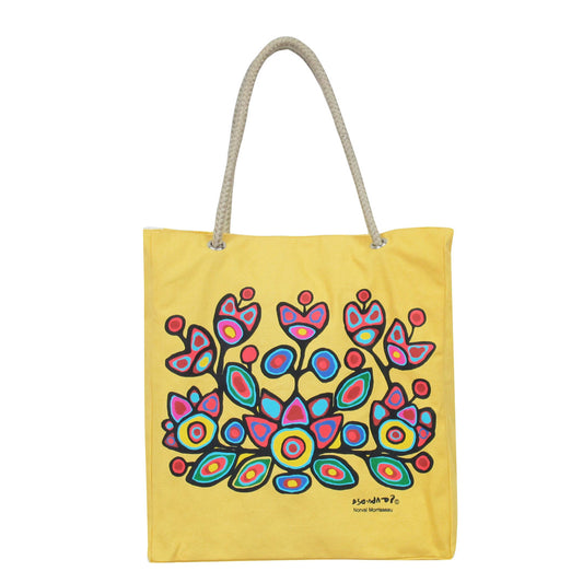 Yellow tote bag with colorful floral design and rope handle on a white background