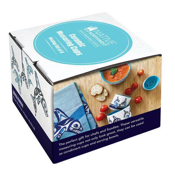 Ceramic Measuring Cups set in its retail packaging, featuring a white box with a teal circular logo and an illustration of Inuit-style patterns.