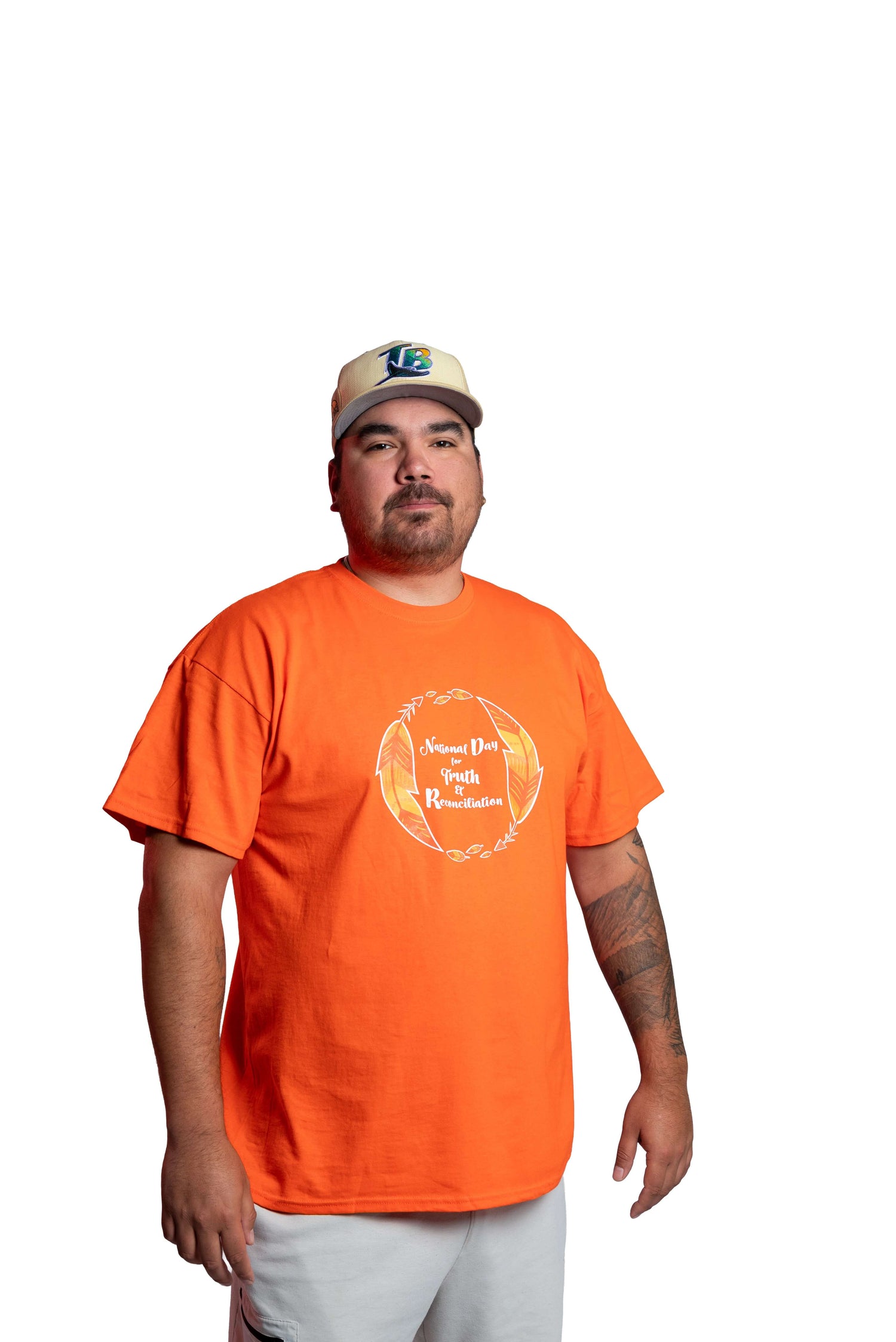 Man wearing an orange Truth and Reconciliation 2025 unisex t-shirt front view