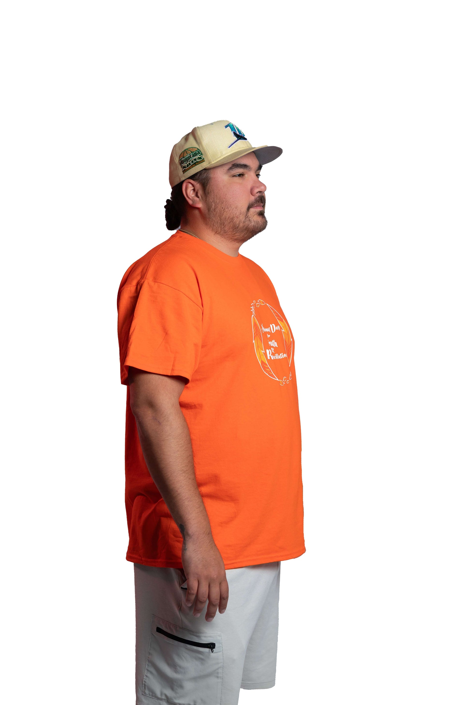 Man wearing an orange Truth and Reconciliation 2025 unisex t-shirt side view