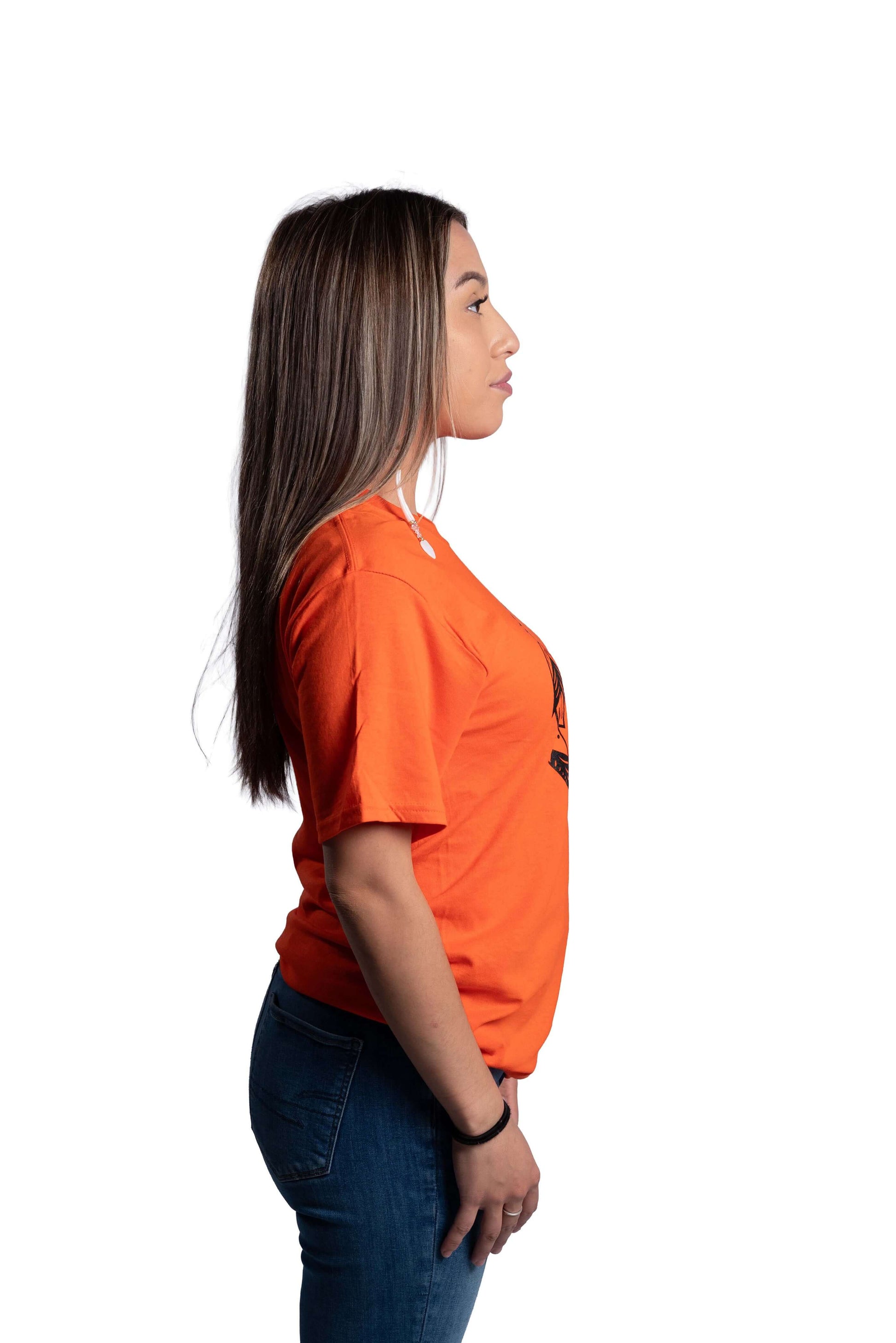 Woman wearing an orange Truth and Reconciliation 2025 unisex t-shirt back view