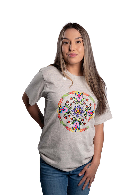 Woman wearing a gray t-shirt with a colorful floral design on a white background