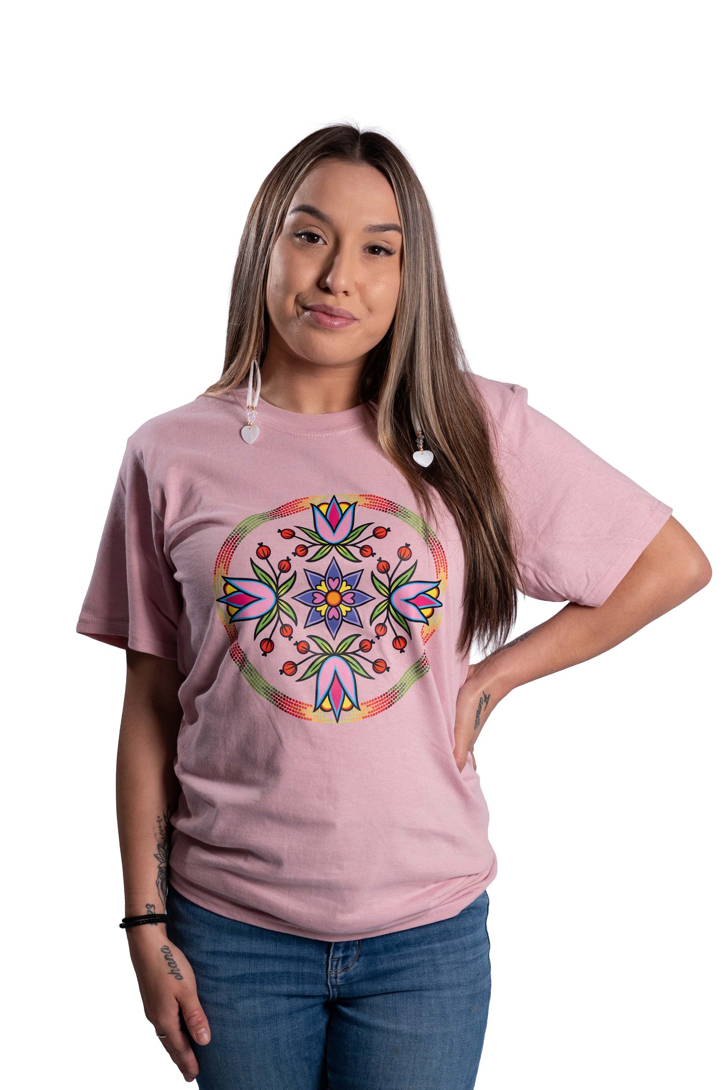 Woman wearing a pink t-shirt with a colorful mandala design on a white background