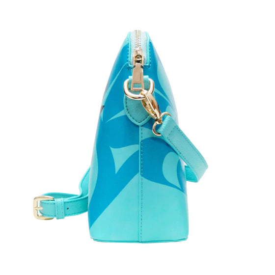 Turquoise handbag with gold accents on a white background