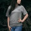 Person wearing Cedar Medicine Tee in grey Indigenous streetwear graphic T-shirt