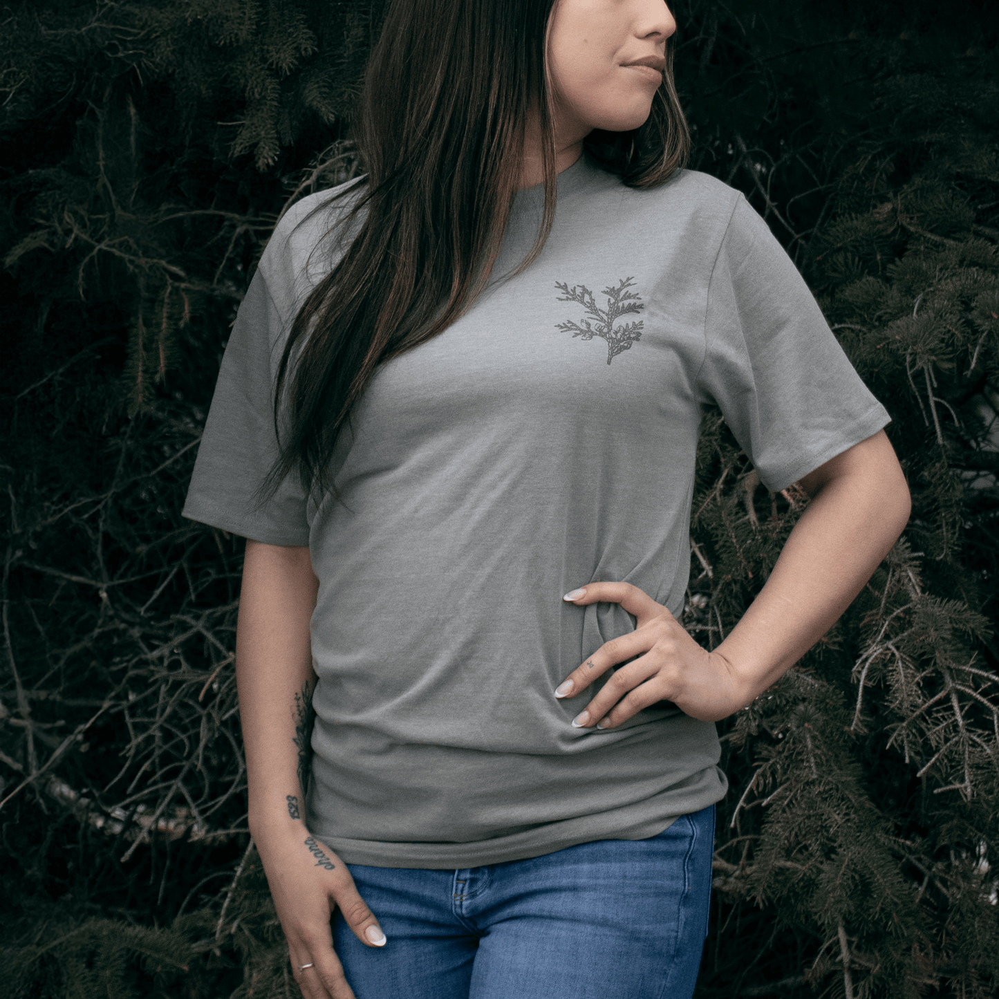 Person wearing Cedar Medicine Tee in grey Indigenous streetwear graphic T-shirt
