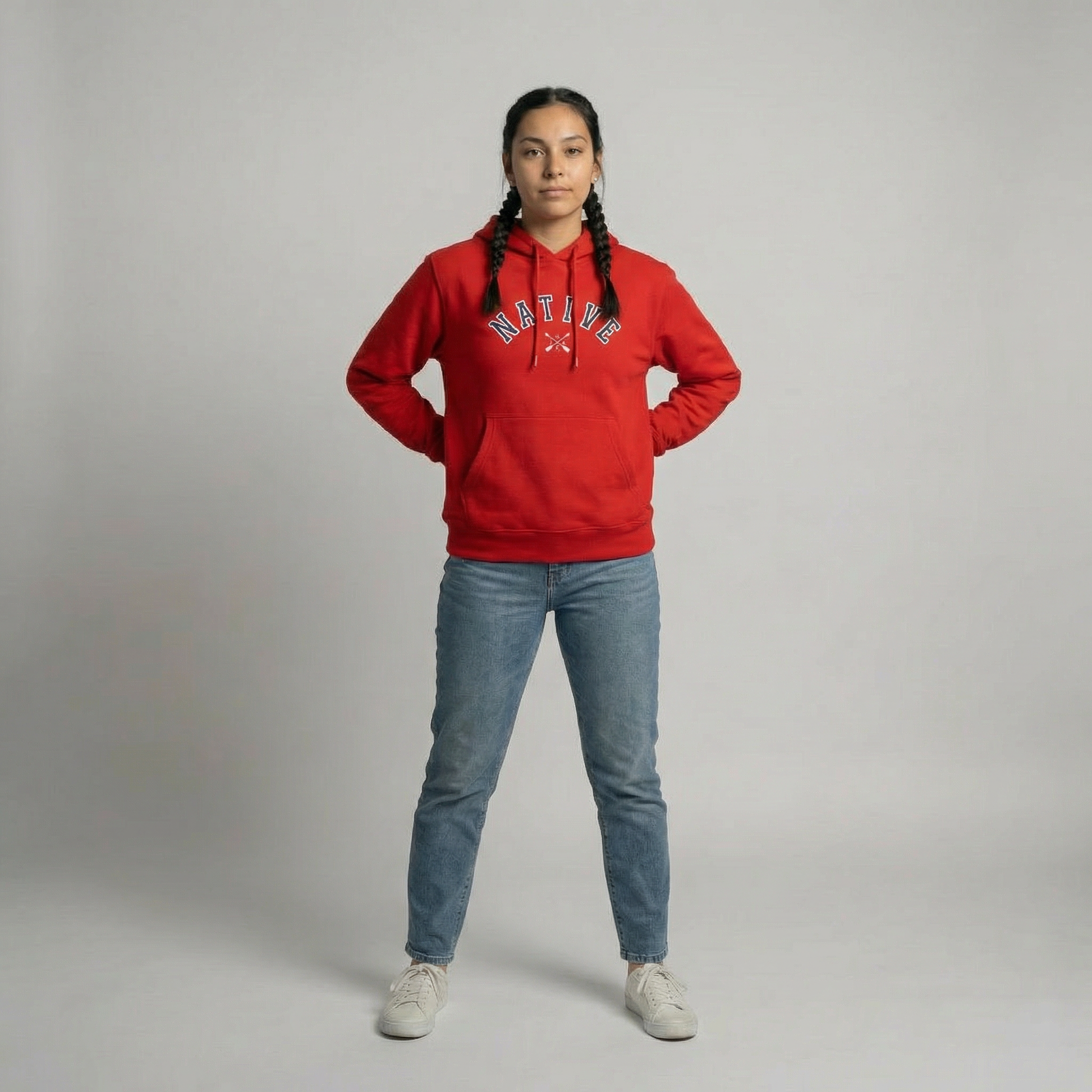 Native Collegiate Hoodie showcased by a model in a red sweatshirt with braids, highlighting Native American heritage and style.