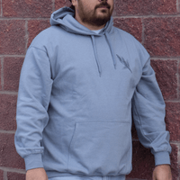 Front view of Sage Medicine Hoodie in light blue Indigenous streetwear with cultural design