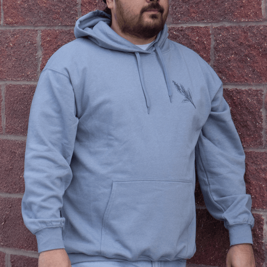 Front view of Sage Medicine Hoodie in light blue Indigenous streetwear with cultural design