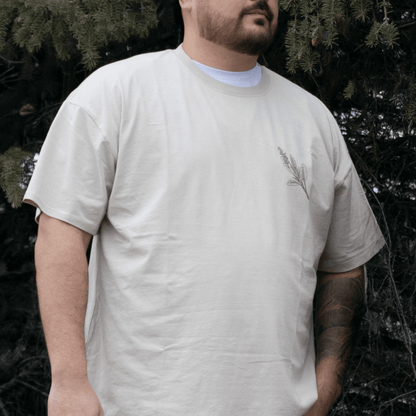 Person wearing Sage Medicine Tee in beige Indigenous streetwear graphic shirt