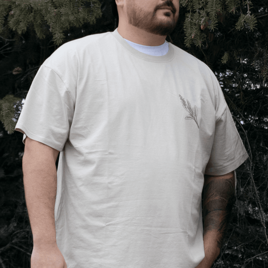 Person wearing Sage Medicine Tee in beige Indigenous streetwear graphic shirt