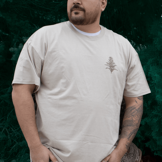 Person wearing Tobacco Medicine Tee in beige Indigenous streetwear graphic shirt