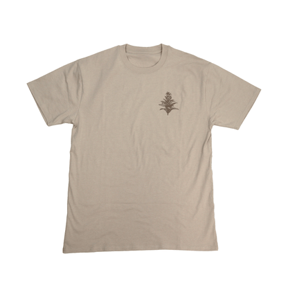 Flat lay front view of Tobacco Medicine Tee in beige with Indigenous design