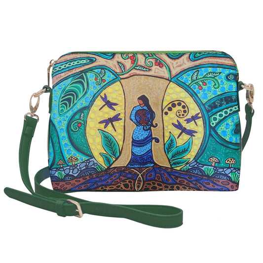 Colorful handbag with artistic design featuring a woman and nature elements on a white background